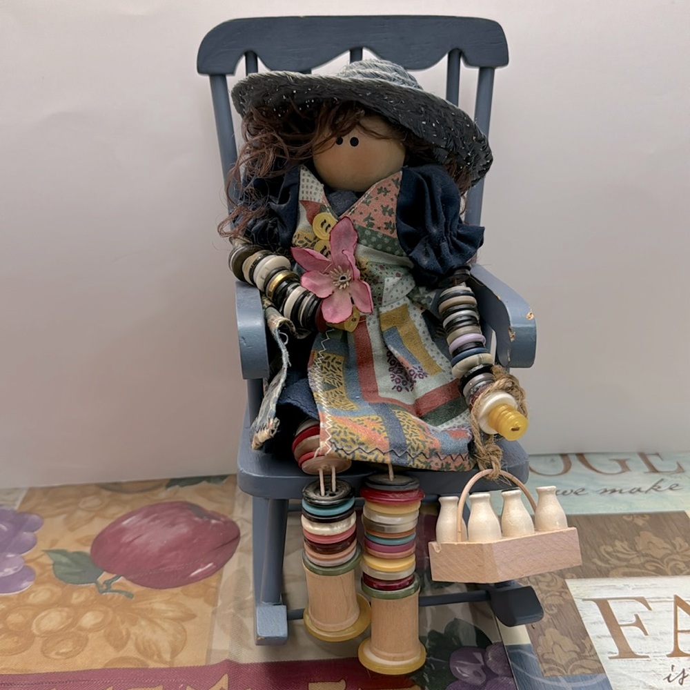 Vintage handcrafted  button milk maid on a racking chair figuring